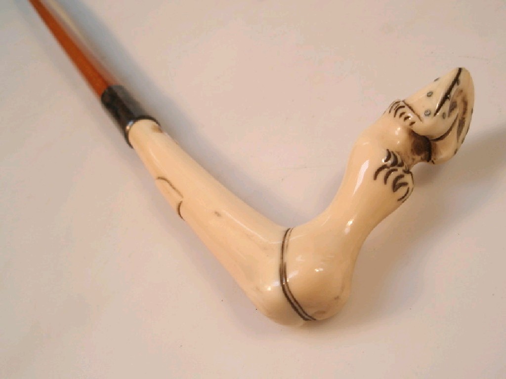 Appraisal: An antique mallaca cane with silver mount the ivory handle