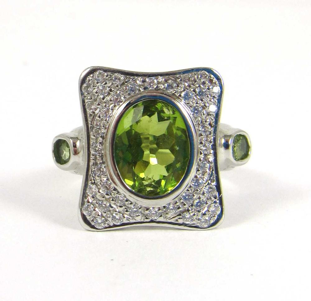 Appraisal: PERIDOT AND FOURTEEN KARAT WHITE GOLD RING pave' set with