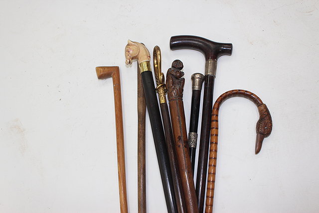 Appraisal: A BAMBOO WALKING CANE with carved swan neck handle an