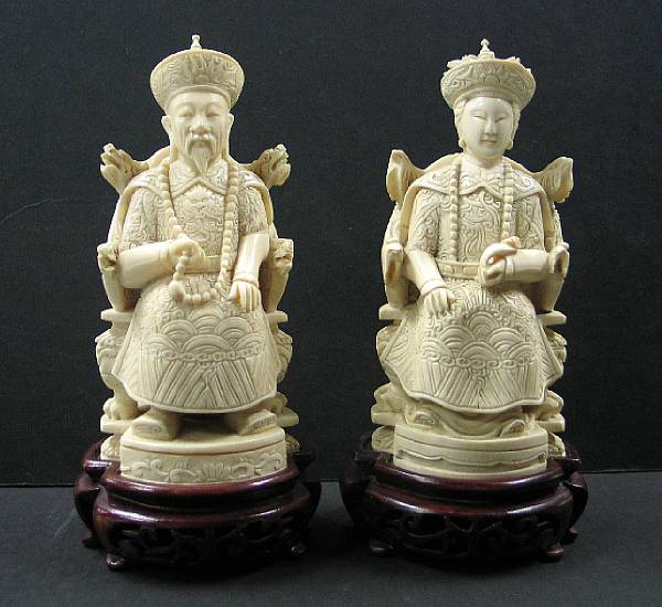 Appraisal: A carved ivory seated emperor and empress The emperor dressed