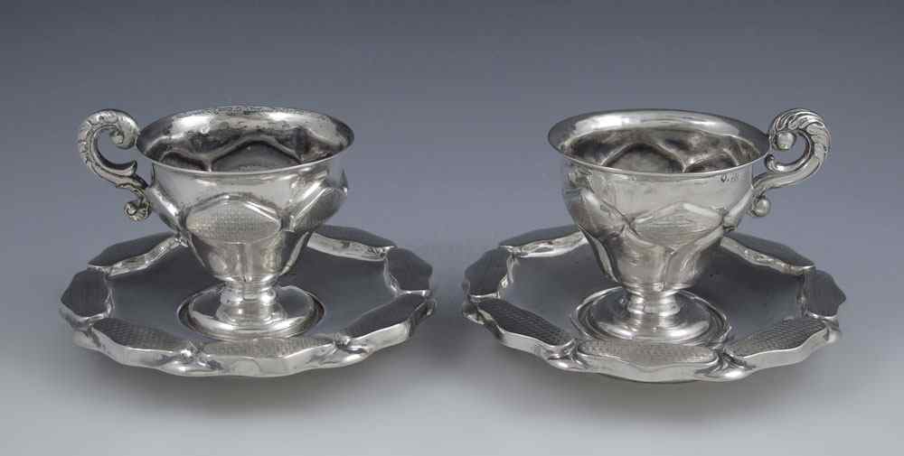 Appraisal: AUSTRIAN SILVER CUPS SAUCERS To include chased and engraved cup