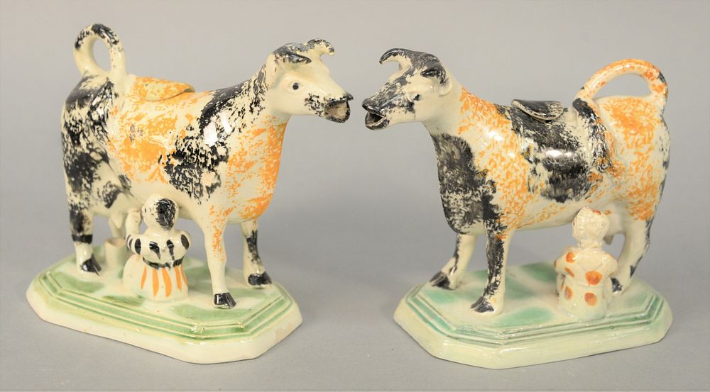 Appraisal: Pair of Pearlware Cow Creamers with milkers spatterware decorated one