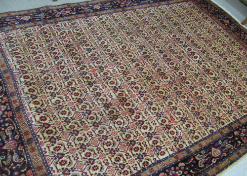 Appraisal: HAND KNOTTED PERSIAN CARPET overall Herati motif on rectangular ivory