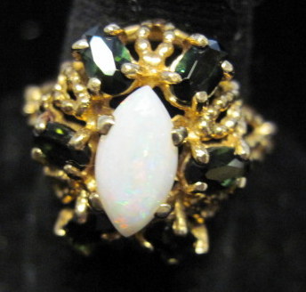 Appraisal: karat yellow gold opal and emerald ring Marquise shaped opal