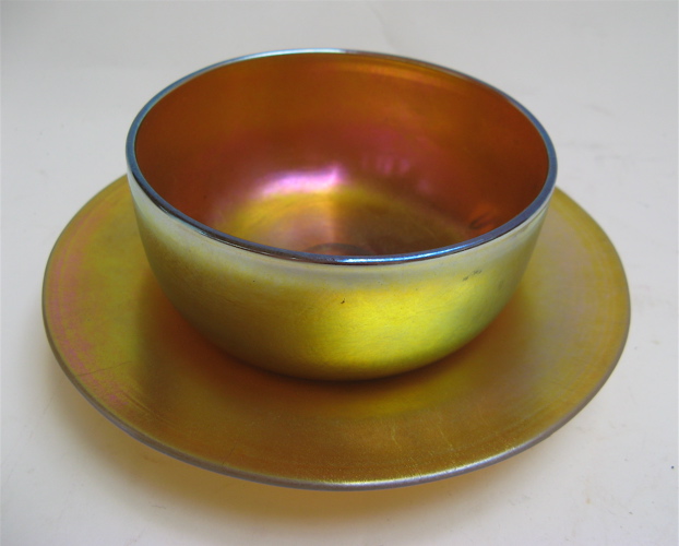 Appraisal: STEUBEN AURENE ART GLASS BOWL AND UNDERPLATE Gold iridescent with