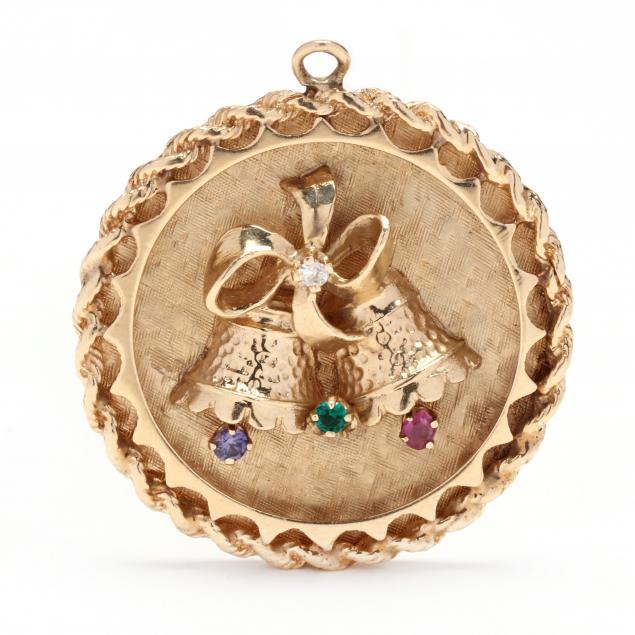 Appraisal: GOLD AND GEM-SET CHARM The round charm with central high-relief