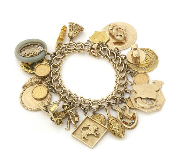 Appraisal: A gold charm bracelet with twenty-three gold and stone charms