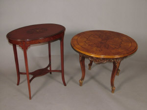 Appraisal: An Edwardian mahogany and inlaid two tier occasional table of