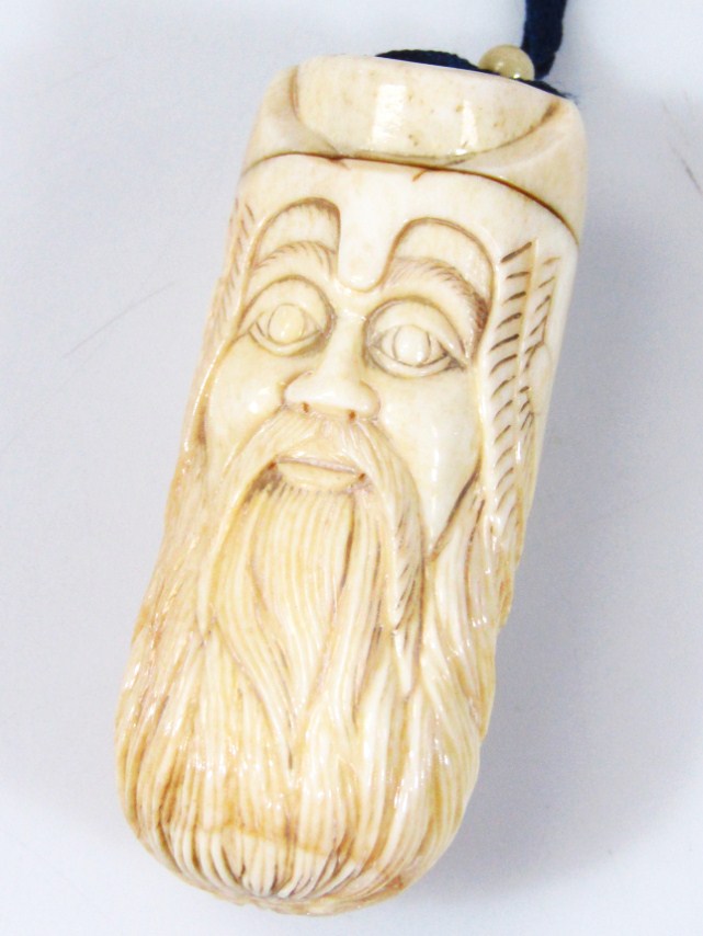 Appraisal: A Japanese sake bottle netsuke formed as a bearded gentleman