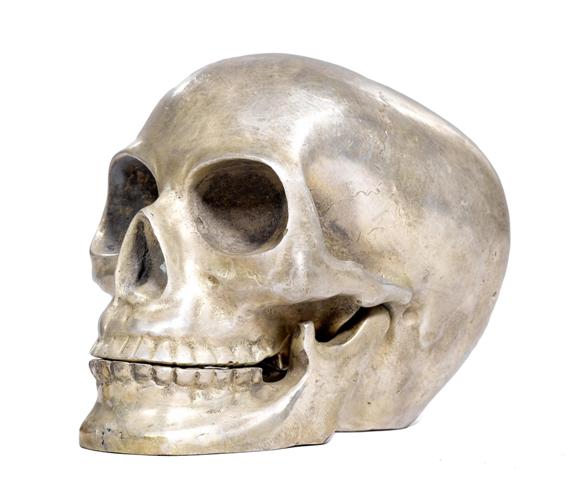 Appraisal: SCULPTURE OF A SKULL modern Silver-colored metal H cm