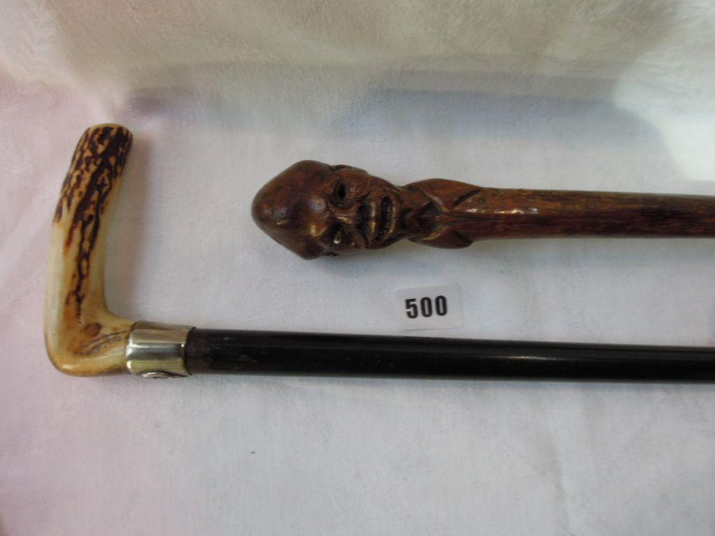 Appraisal: An ebony cane with silver metal collar crested with the