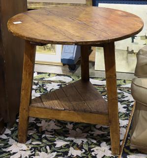 Appraisal: English stained pine cricket table having a circular top above