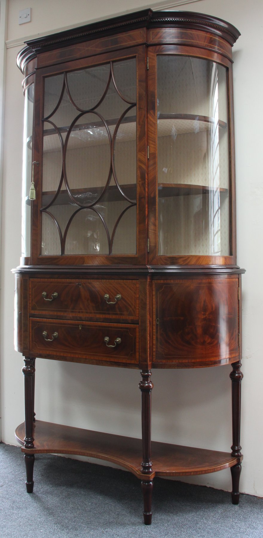 Appraisal: An Edwardian mahogany display cabinet the bowfronted upper part with