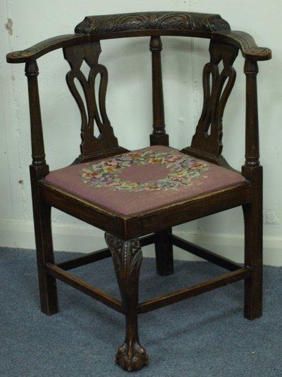 Appraisal: A carved oak corner chair with pierced and turned splats