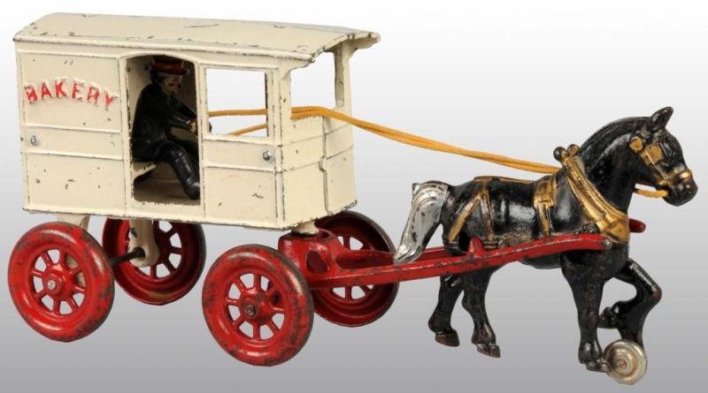 Appraisal: Cast Iron Kenton Horse-Drawn Bakery Wagon Toy Description Pulled by