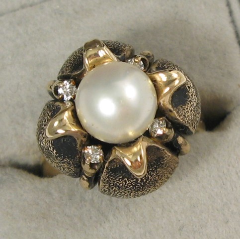 Appraisal: PEARL DIAMOND AND TWELVE KARAT GOLD RING centering a mm