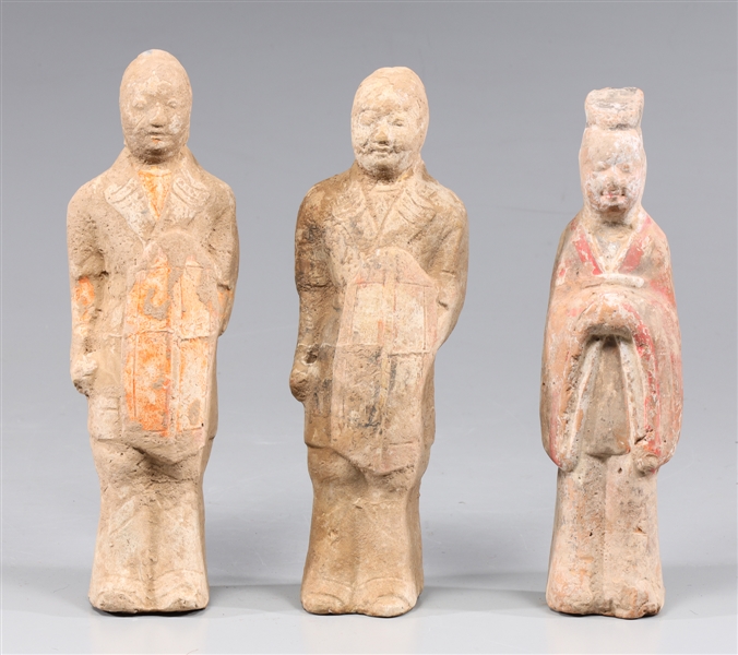 Appraisal: Three antique probably Tang dynasty ceramic standing figures a pair