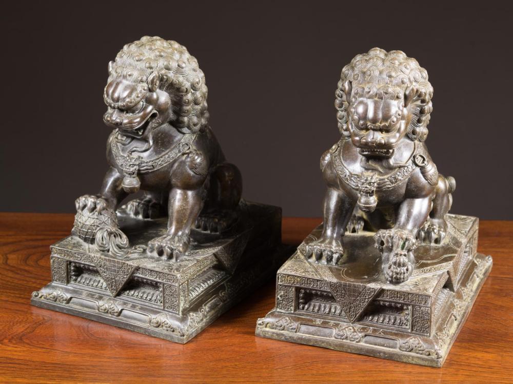 Appraisal: PAIR OF CHINESE BRONZE FOO-LIONS depicting one male the other