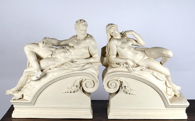 Appraisal: A PAIR OF PLASTER FIGURES OF A MAN AND A