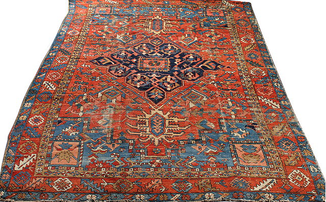 Appraisal: AN ANTIQUE HERIZ BRICK GROUND LARGE RUG with central blue