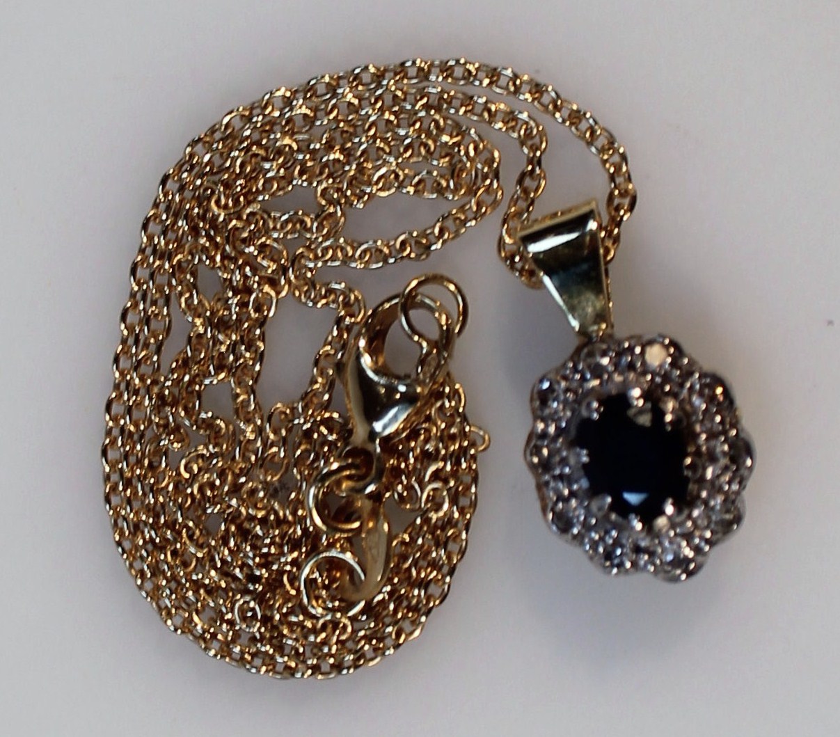 Appraisal: A ladies necklace with floral pendant claw set with central