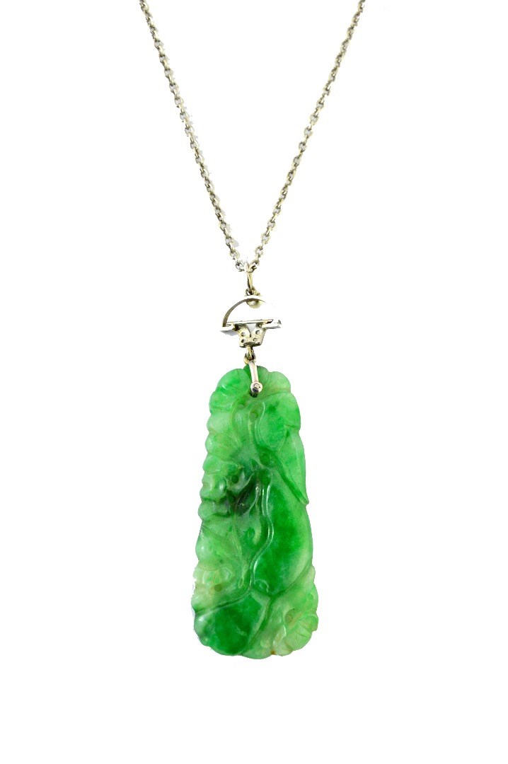 Appraisal: A carved jade pendant in a tapering panel shaped design