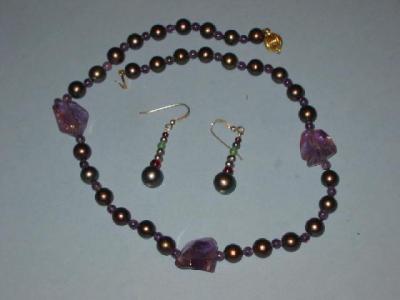 Appraisal: A CULTURED BLACK PEARL NECKLACE the uniform beads with amethyst