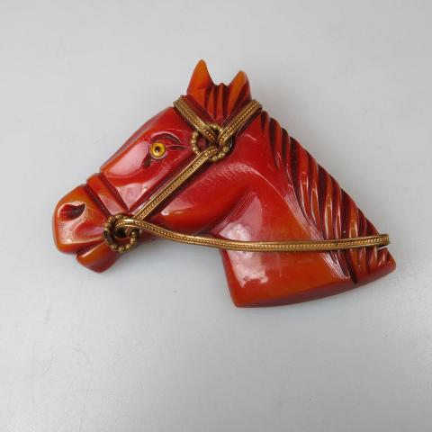 Appraisal: Red Bakelite Horse Head Pin with overlain gold-tone metal decoration