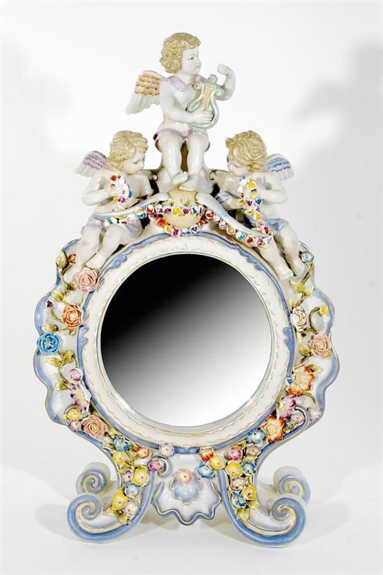 Appraisal: French style porcelain table-top looking glass three cherubs seated atop