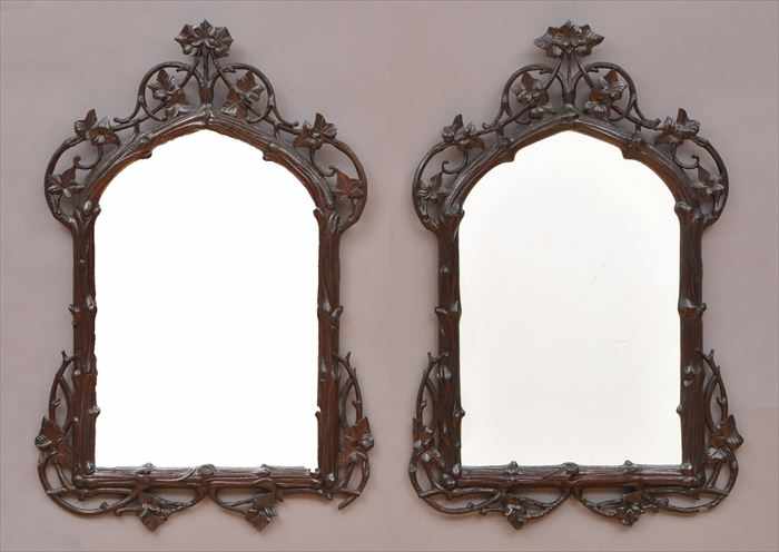 Appraisal: PAIR OF BLACK FOREST CARVED WOOD WALL MIRRORS Each with