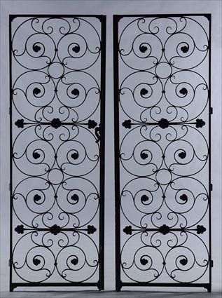 Appraisal: PAIR OF WROUGHT IRON GATES Partially gilded x in overall