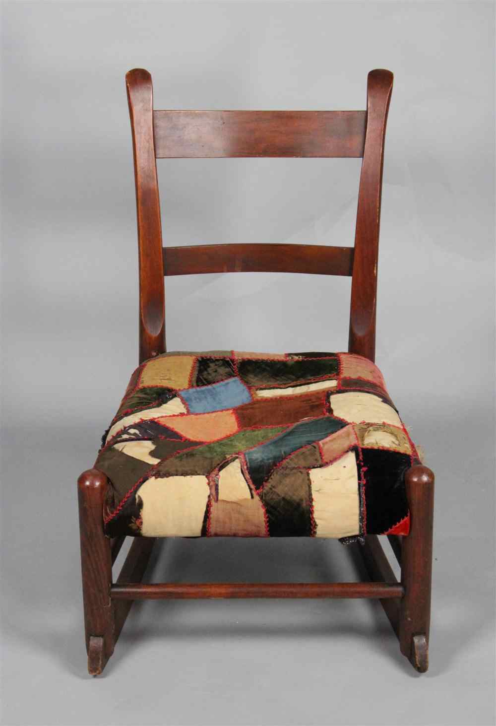 Appraisal: CHILD'S ROCKING CHAIR WITH PATCH WORK SEAT having a mixed