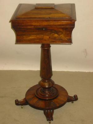 Appraisal: A VICTORIAN ROSEWOOD TEAPOY of oblong sarcophagus form with hinged