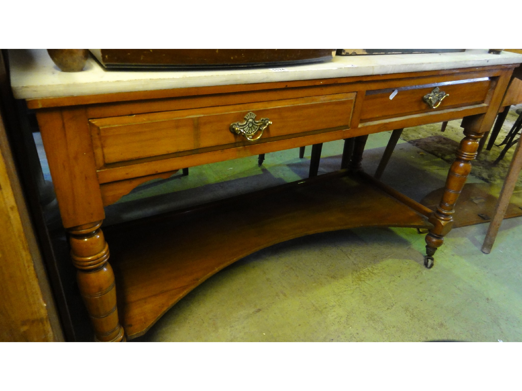 Appraisal: An Edwardian walnut marble top washstand fitted with two shallow