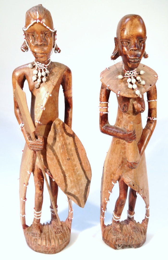 Appraisal: A pair of thC heavily carved tribal figures each standing