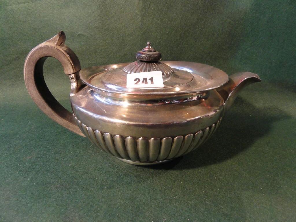 Appraisal: A silver teapot of baluster form with fluted border and