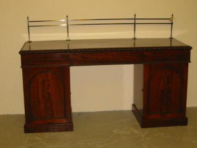 Appraisal: AN EARLY VICTORIAN MAHOGANY PEDESTAL SIDEBOARD the associated brass rail