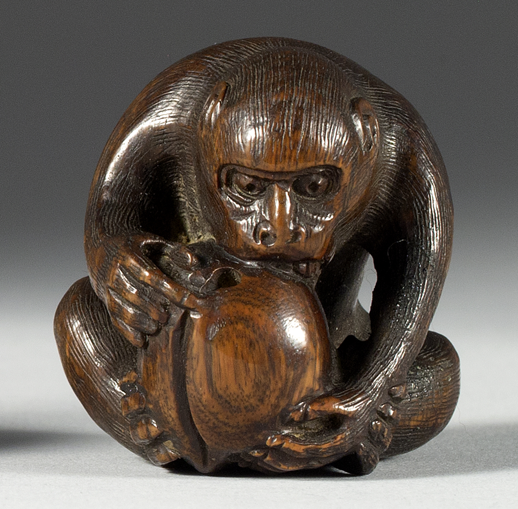 Appraisal: WOOD NETSUKE Circa In the form of a monkey guarding