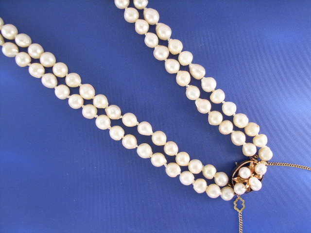 Appraisal: A mm double strand cultured baroque pearl necklace set with