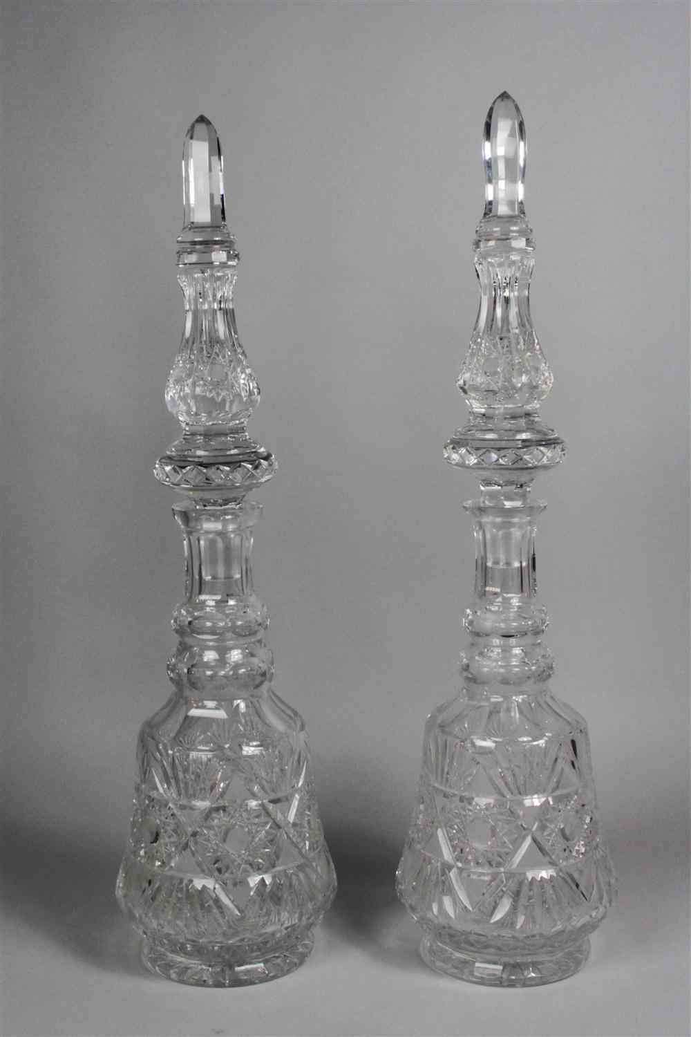 Appraisal: TWO MASSIVE CUT GLASS DECANTERS WITH STOPPERS with paneled spire