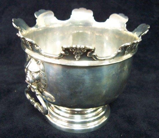 Appraisal: A rose bowl with coronet scroll border having lion mask