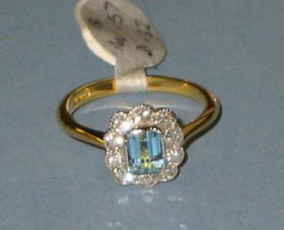 Appraisal: AN AQUAMARINE AND DIAMOND RING the emerald cut aquamarine set