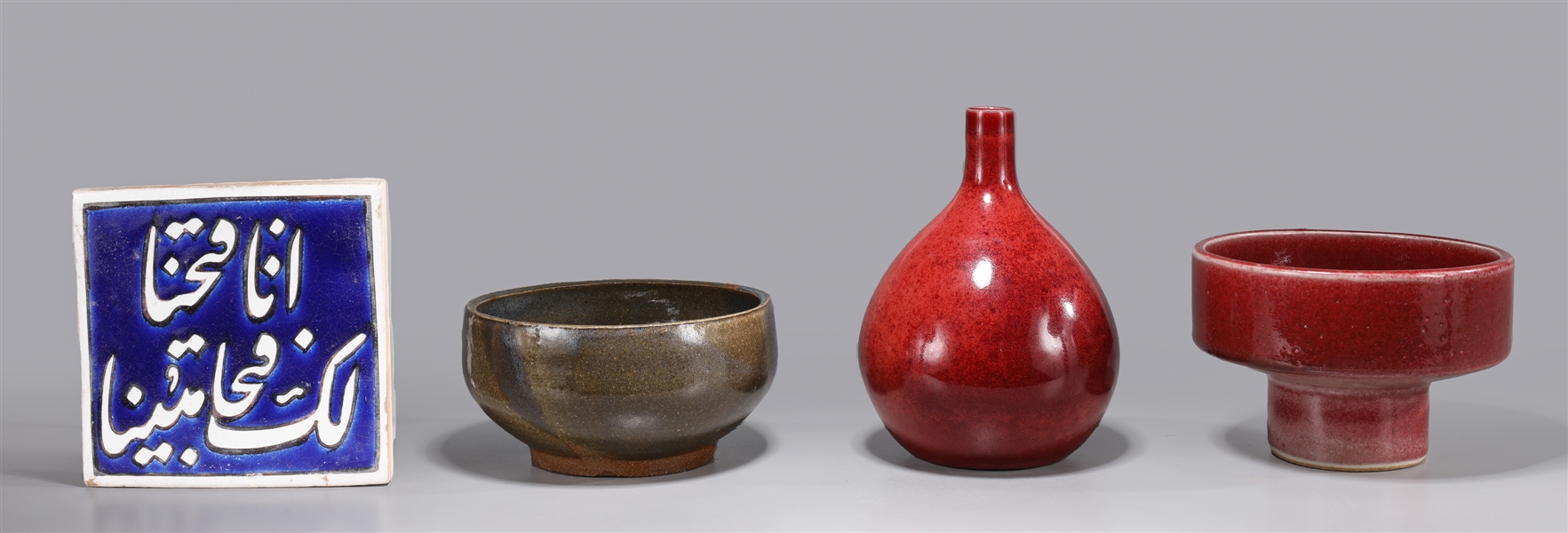 Appraisal: Four various ceramic pieces including red bottle vase with signature