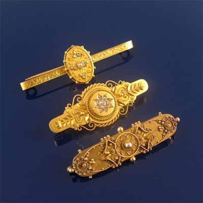 Appraisal: Three gold brooches in the Etruscan style two set with