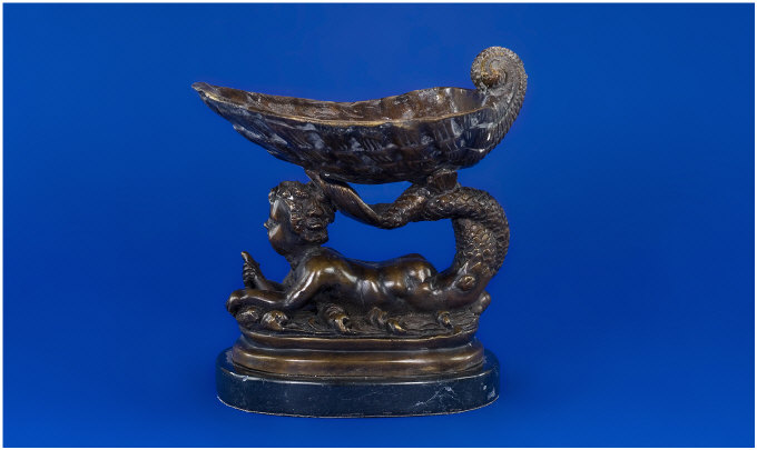 Appraisal: Bronze Figure of a Mythical Merboy holding a large sea