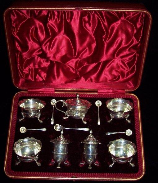 Appraisal: A silver cruet set in a box Sheffield comprising seven