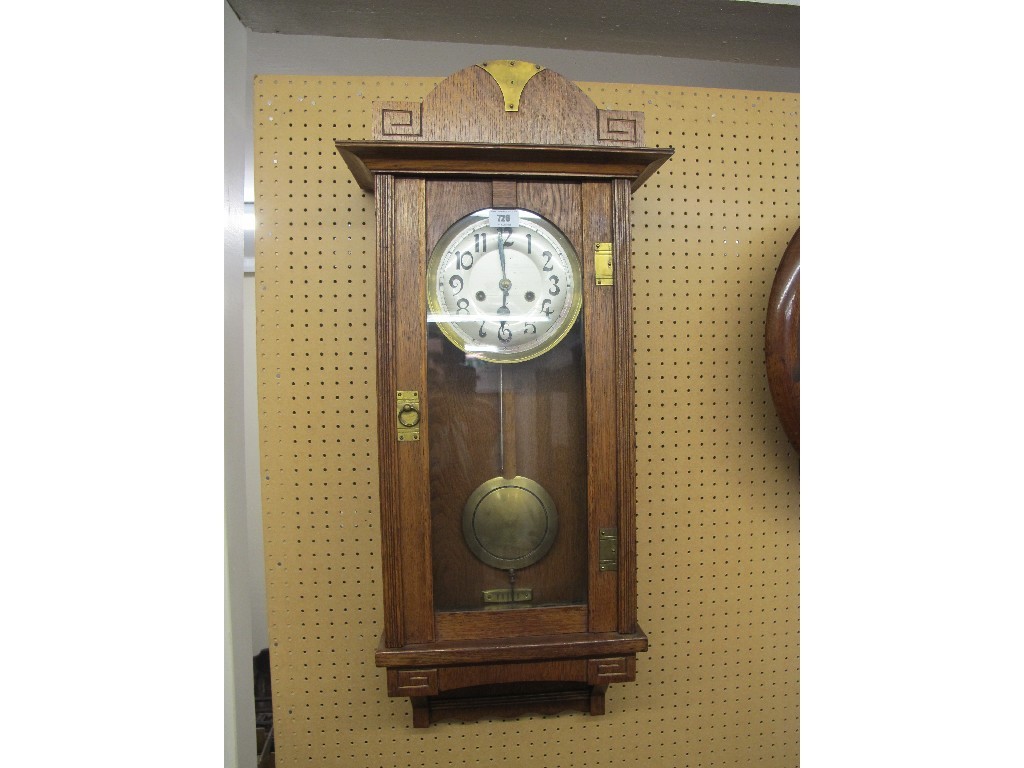 Appraisal: Arts and Crafts oak and brass bound wall clock