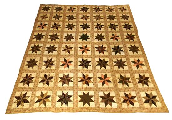 Appraisal: th C American cotton patchwork quilt hand-sewn cream-colored ground tan