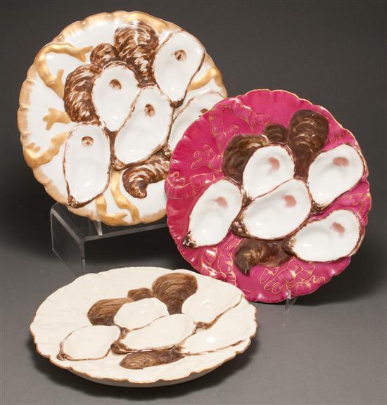 Appraisal: Two Limoges painted parcel-gilt porcelain oyster plates and a similar