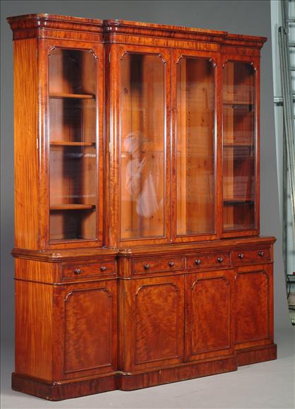 Appraisal: A Victorian mahogany breakfront bookcase circa the cornice above a